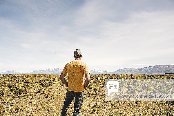 Rear view of man standing in remote landscape in Patagonia  Argentina