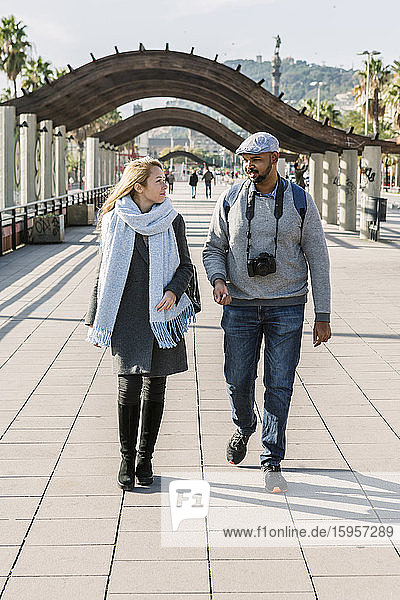 Couple walking together on promenade  Barcelona  Spain