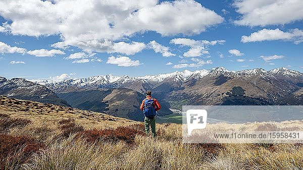 Hiker on the summit of Mount Alfred  panoramic views of the mountains  Glenorchy near Queenstown  Southern Alps  Otago  South Island  New Zealand  Oceania