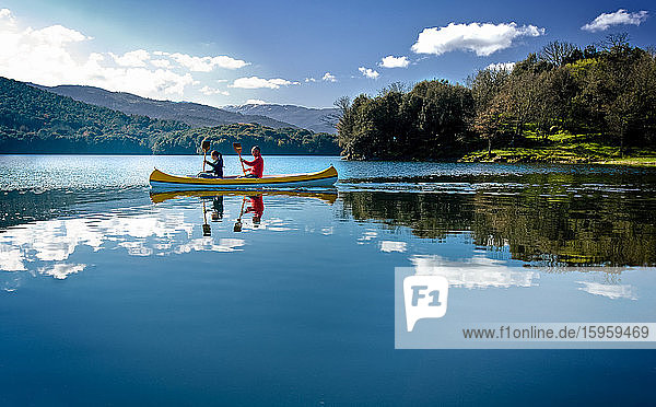 Couple canoeing on Gusana lake  an artificial lake in the territory of Gavoi  Sardinia  Italy.