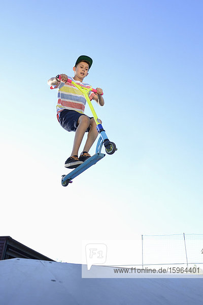 Junge mit Kickboard in einem Skatepark