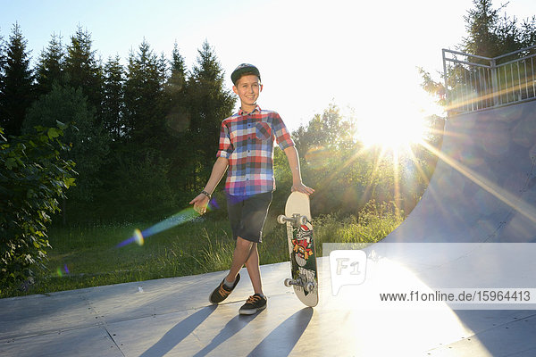 Boy with skateboard in a skatepark