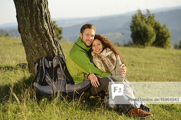 Smiling couple at a tree