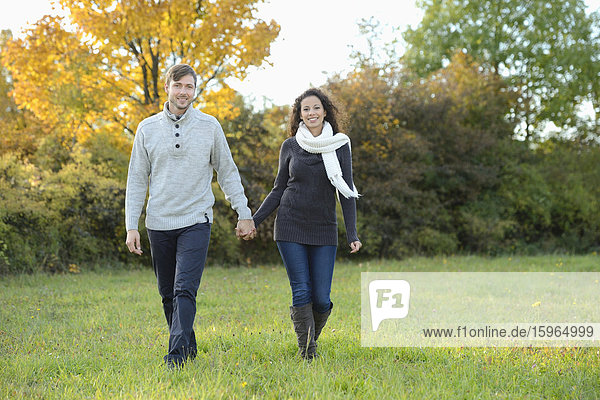 Smiling couple walking in autumn