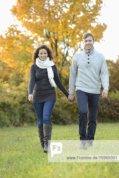 Smiling couple walking in autumn