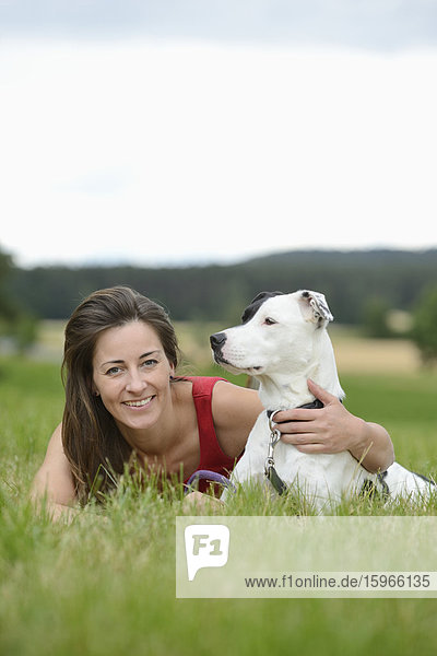Woman with a mongrel dog on a meadow  Bavaria  Germany  Europe