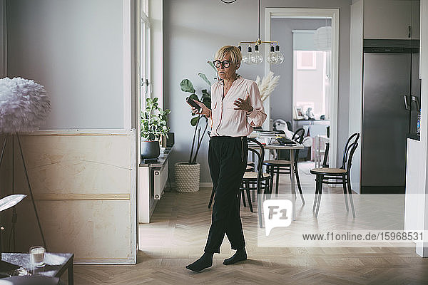 Woman working at home on the phone having a conversation