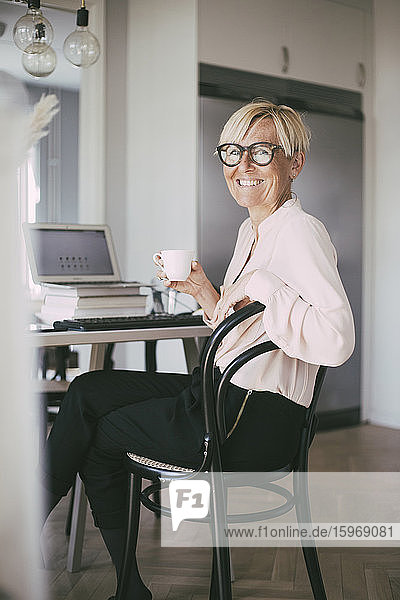 Portrait of smiling woman working at home
