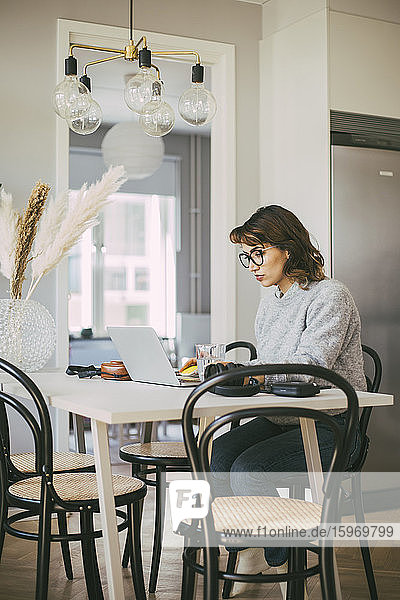 Woman at table working at home