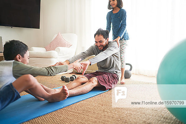 Playful family exercising in living room