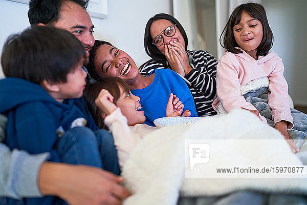 Happy family laughing on sofa
