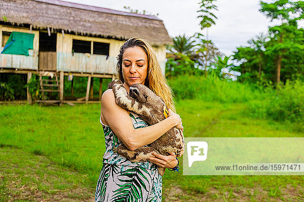 Visitor holding a local Sloth  Peru  South America