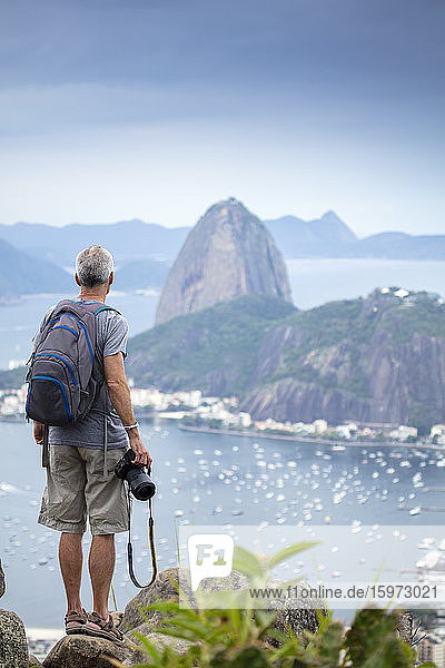 A photographer shooting the the famous Sugar Loaf mountain in Rio de Janeiro  Brazil  South America