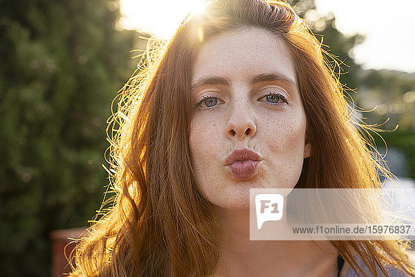 Portrait of redheaded woman with kissing lips