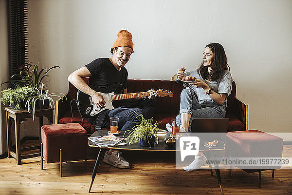 Couple relaxing together on the couch at home