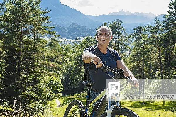 Senior man with e-bike