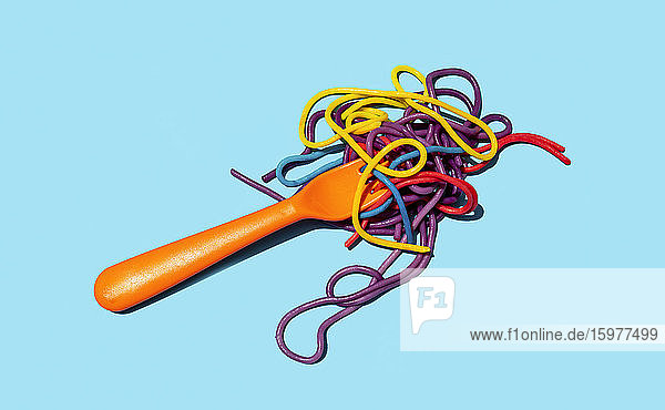 Studio shot of fork with colorful pasta