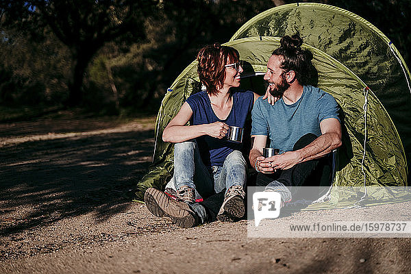 Happy couple camping in the countryside