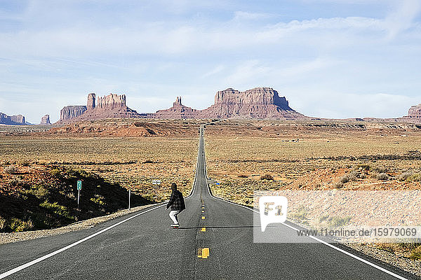 Full length of man skateboarding on desert road  Monument Valley Tribal Park  Utah  USA