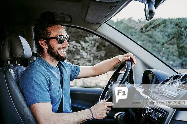 Happy man driving car