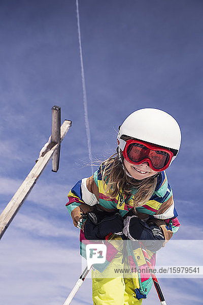 Low angle view of excited girl skiing against sky during winter at Spitzingsee  Bavaria  Germany