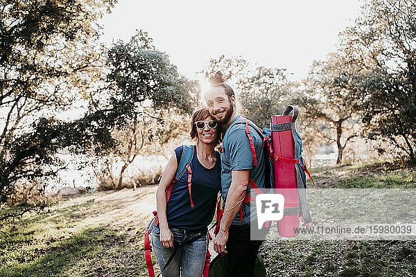Happy couple with backpacks on a hiking trip