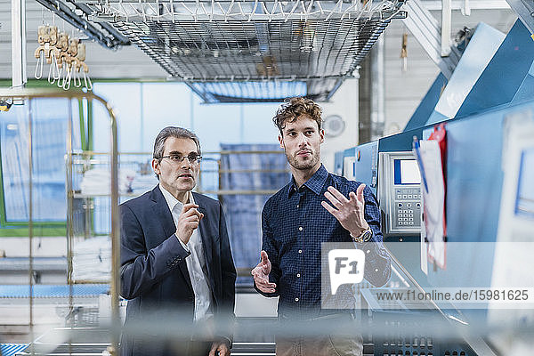 Two businessmen discussing in a factory