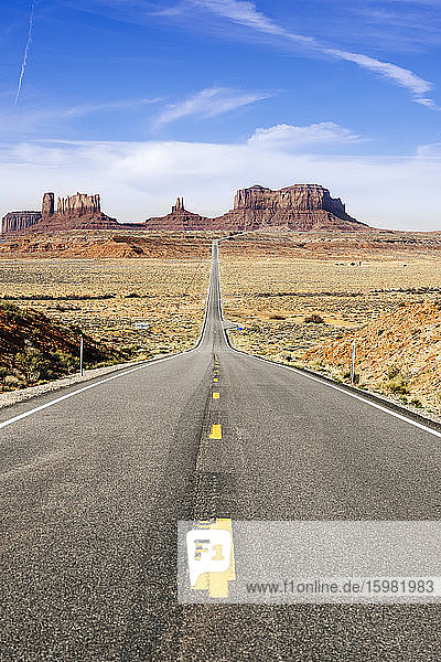 Empty desert road towards famous rock formation against sky  Monument Valley Tribal Park  Utah  USA