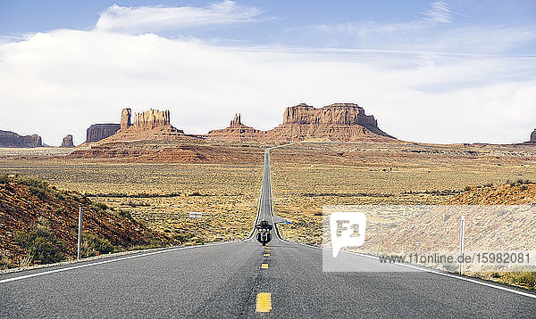 Man riding motorcycle on the desert road  Monument Valley Tribal Park  Utah  USA