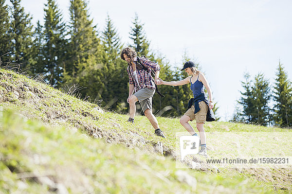 Hiking couple on meadow in summer  Wallberg  Bavaria  Germany