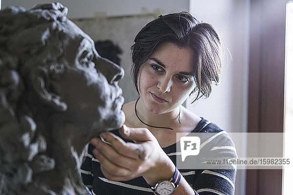 Female student looking at bust of woman