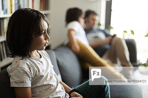 Boy sitting on couch at home watching television
