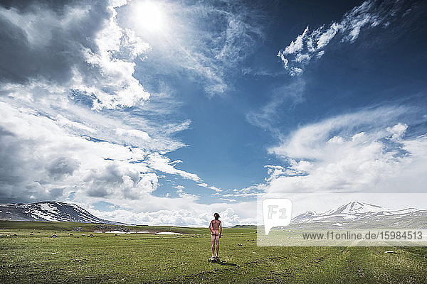 Georgia  Samtskhe-Javakheti  Male nudist standing in grassy plateau under shining sun