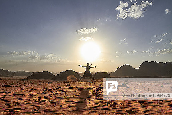 Frau  die in der Wüste von Wadi Rum  Jordanien  über den roten Sand springt