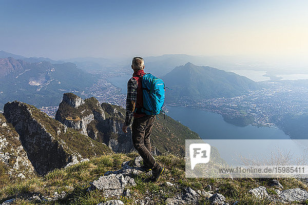Rear view of hiker on mountaintop  Orobie Alps  Lecco  Italy