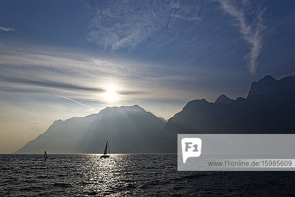 Italy  Trentino  Torbole  Lake Garda surrounded with mountains at sunset