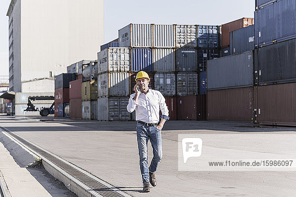 Businessman on the phone at industrial site