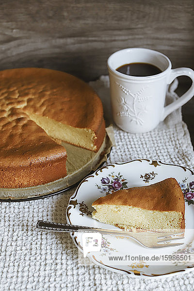 Marzipan cake slice on plate and coffee cup