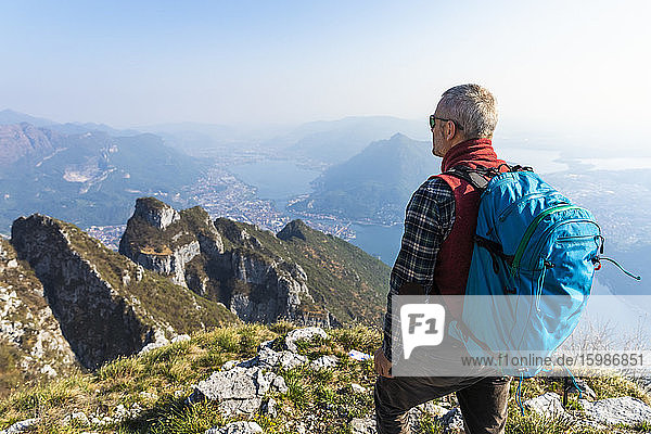 Rear view of hiker on mountaintop  Orobie Alps  Lecco  Italy