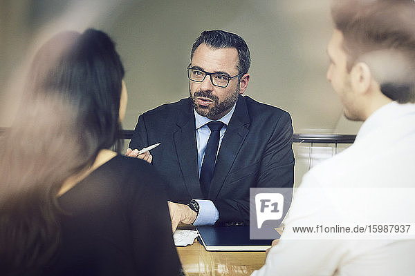 Selbstbewusster  reifer männlicher Anwalt diskutiert mit Kunden im Büro