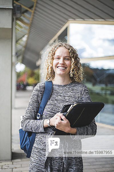 Portrait of smiling young woman at university