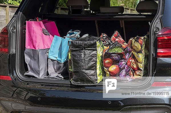Shopping bags and the weekly shop in boot of a car Hampshire England UK.