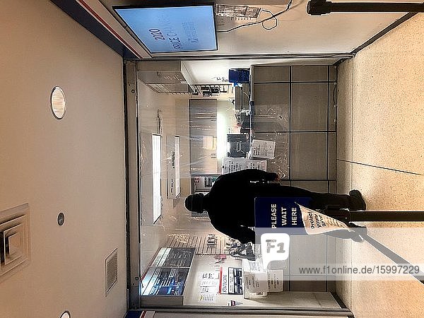 Post Office interior showing protective plastic curtains to protect staff and customers during the Coronavirus crisis in Chicago.