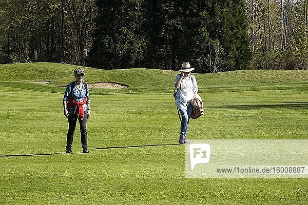 People walk on a golf course in Vancouver  BC  Canada during the covid-19 epidemic.