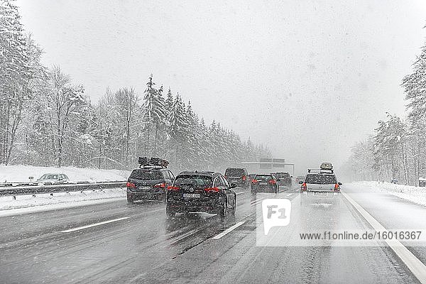 Bad weather heavy car traffic during heavy snowfall and rain on the A8 motorway near Munich Bavaria Germany Europe