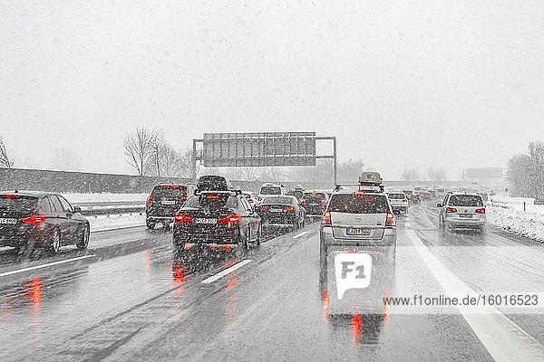 Traffic jam bad weather heavy traffic during heavy snowfall and rain on the A8 motorway near Munich Bavaria Germany Europe