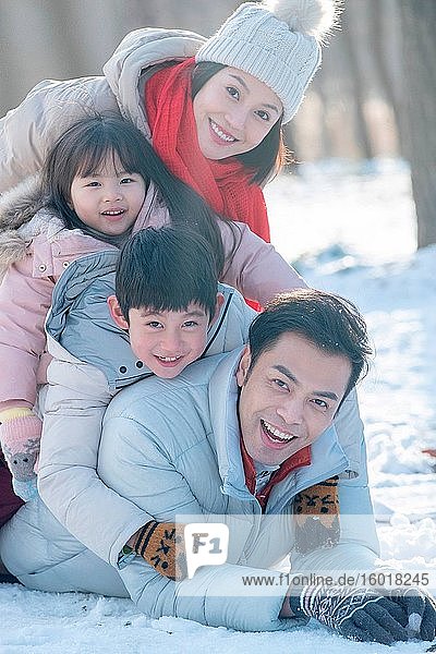Lying on the snow to play happy family