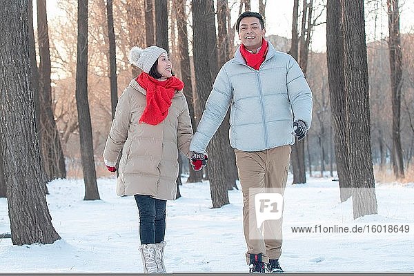 The young couple walking on the snow
