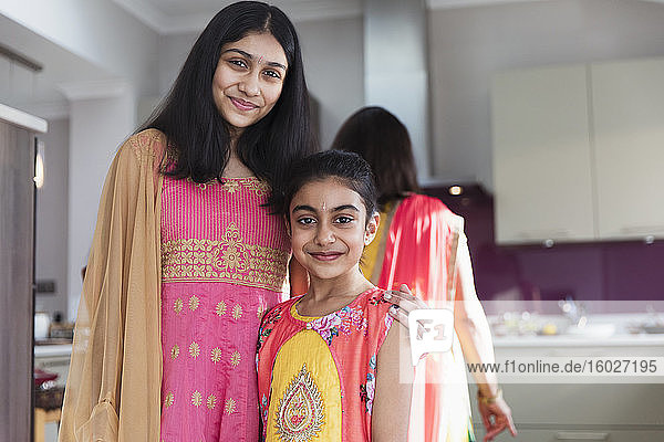 Portrait happy Indian sisters in saris