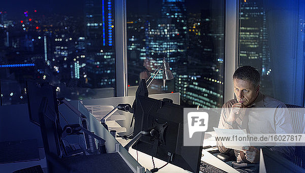 Businessman working late at computer in office